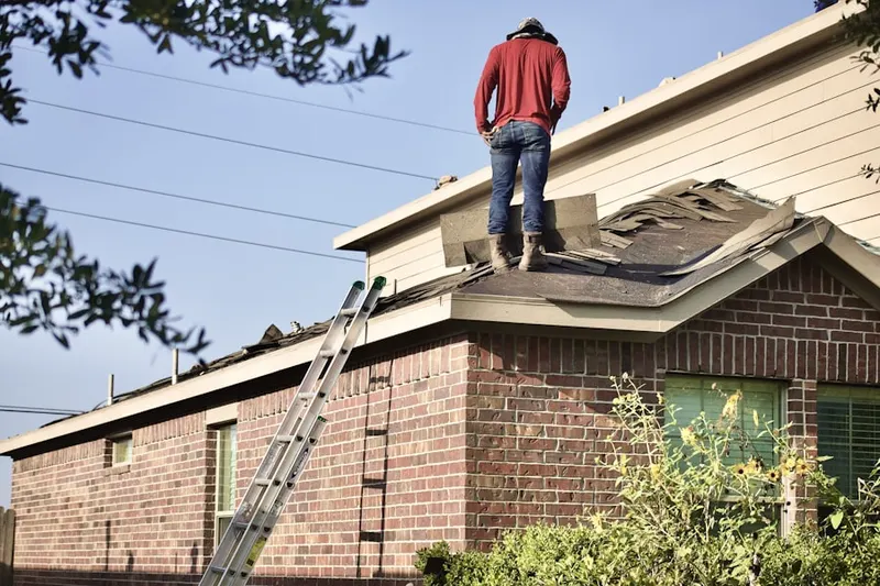 Professional roofer working on a residential roof in Encino Park